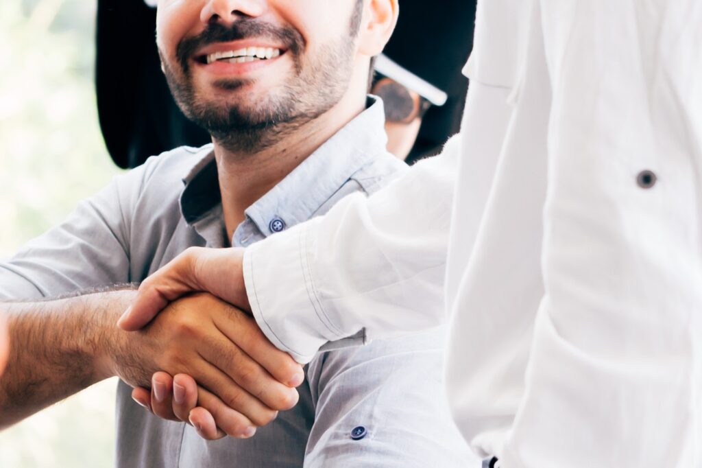 Businessmen shaking hands in office